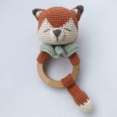 Hand-crocheted sleepy fox baby rattle with wooden teething ring